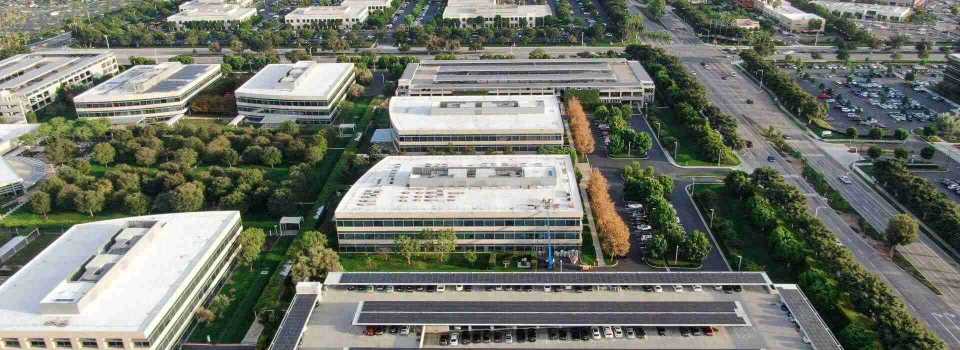 aerial-view-business-finance-district-with-new-office-building-surrounded-by-parking-road